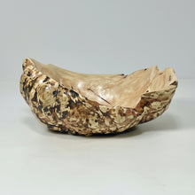 Decorative burl bowl with gold and brown patterns on a gray background